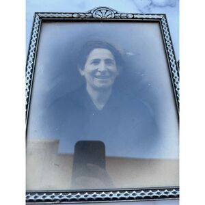 Vintage photograph smiling Caucasian woman black braided hair framed with glass